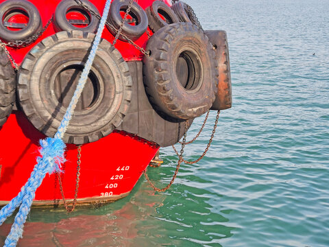 Bow of Red Ship with Tires and Rope