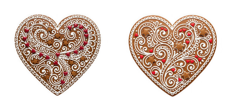 Two decorated gingerbread hearts with white icing, red sugar hearts, and brown sugar stars isolated on transparent background