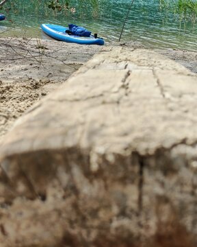 A photo of a bright SUP board against a beautiful background. Paddle board.