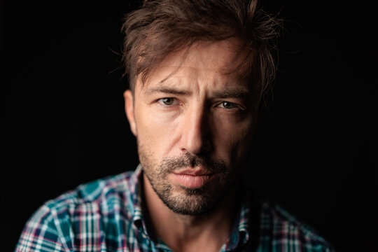 Intense man with messy hair looking forward