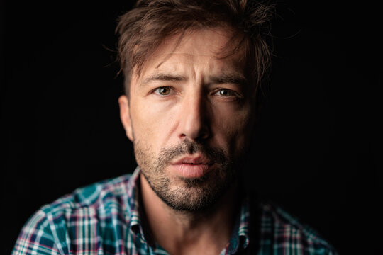 Serious man with messy hair looking forward