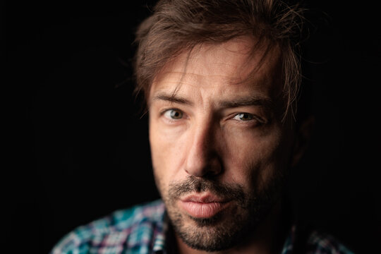 Serious casual man in checkered shirt looking forward