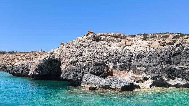 A boat cruise along the Mediterranean Sea's rocky coastline and cave. Active recreation, tourism, and sightseeing in Protaras, Cyprus.