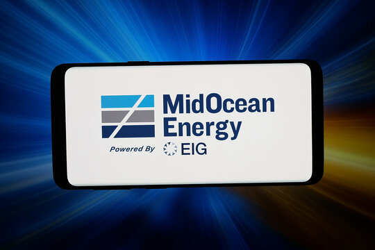 Stuttgart, Germany - 06-17-2026: In this photo illustration, the logo of LNG company MidOcean Energy (EIG) is displayed on a smartphone in front of abstract background on computer screen.