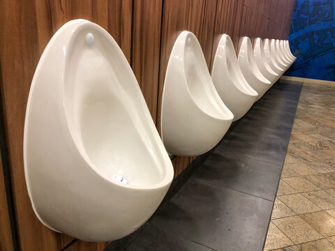 Row of urinals in a male toilet.