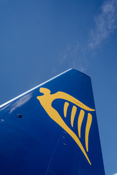 Detailed view of the rear section of a Ryanair aircraft featuring the tail fin and horizontal stabilizer beneath a clear blue sky. A strong aviation image illustrating commercial air transport and mod