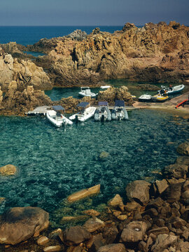 boats in crystal clear waters in Sardinia