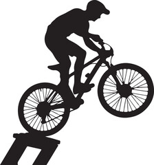 Fototapeta premium Silhouette of a mountain biker performing a jump on a ramp