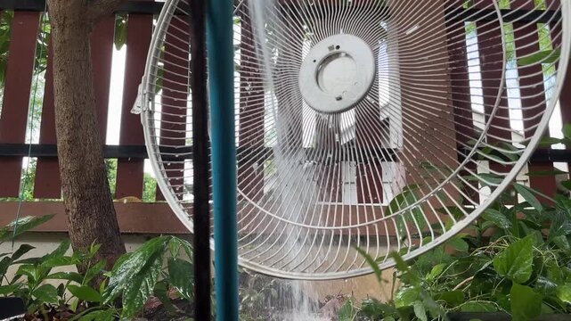 Water from pipe flow freely cleaning fan grill at home outdoor