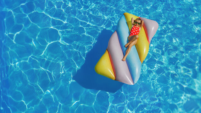 Child in swimming pool. Having fun on vacation at the hotel pool. Colorful vacation concept.