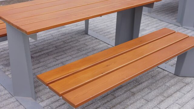 Modern outdoor wooden table and bench in residential courtyard