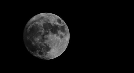 Fototapeta premium Full moon isolated on black background