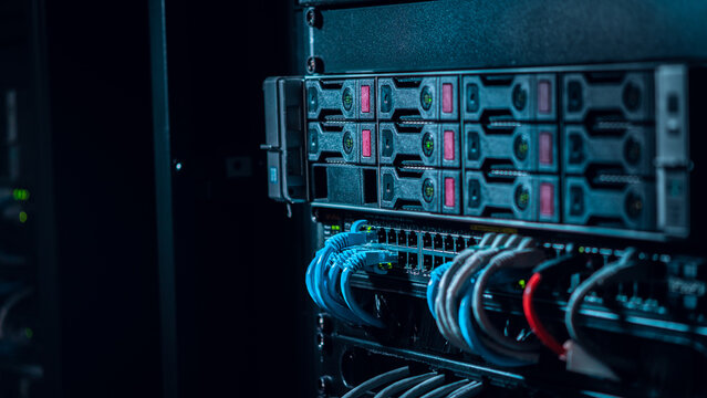 View of a server rack with organized blue and red ethernet cables connected to networking hardware in a data center in Los Angeles, California, United States.
