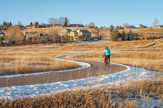meandering biking trail in Fort Collins, Colorado with a lone ly cyclist