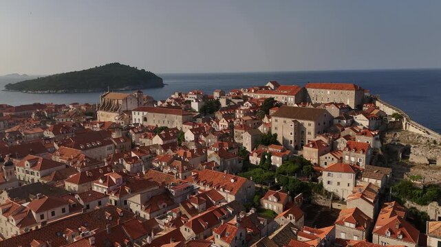 Aerial orbit left over Dubrovnik old town rooftops with St Ignatius church and Rupe museum 4K