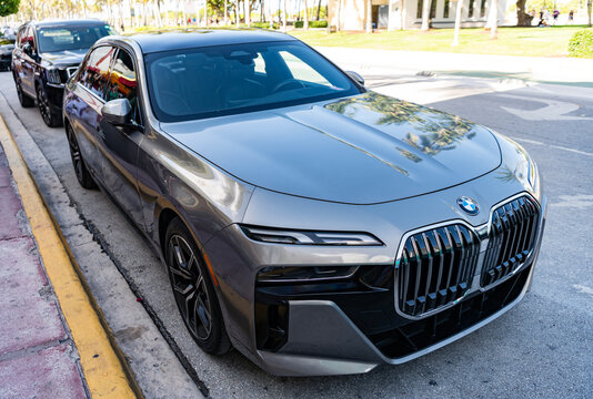 Miami, Florida, USA - July 27, 2025: Grey electric saloon car, low view. BMW i7 G70 generation 2023 sedan or saloon electric car. Luxury electric sedan car BMW i7 G70. Car BMW i7 G70 parked outdoor
