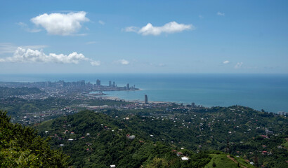 Fototapeta premium High angle panoramic view of Batumi city skyline and the Black Sea coast from the surrounding green hills