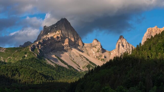 Mountain peak (Tete de Vacheres) of Devoluy Massif in Vercors Park, French Alps. Timelapse with passing clouds in La Jarjatte Valley at sunset. Drome, France