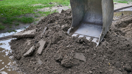 Picking up ground, soil.Road repair with excavator bucket © Igor