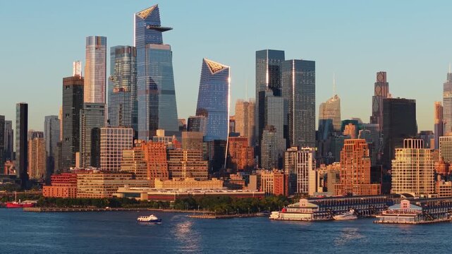 Aerial view of New York City Midtown West Manhattan and Chelsea, featuring Hudson Yards, and landmark skyscrapers. Riverfront along the Hudson River in summer