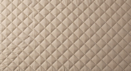 Fototapeta premium Quilted fabric texture with diamond pattern in light beige color showing soft textile material for luxury bedding or upholstery design