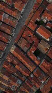 Vertical top down aerial view tracking along Stradun main street in Dubrovnik at twilight 4K