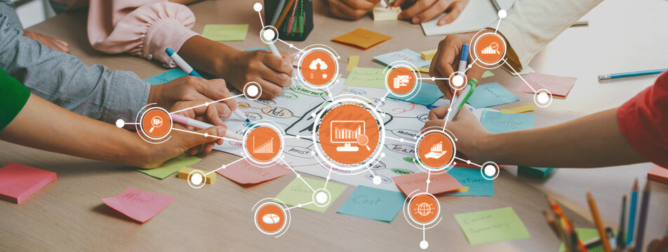A dynamic brainstorming scene showing diverse hands engaged in collaborative idea generation using colorful sticky notes for project development. Amity
