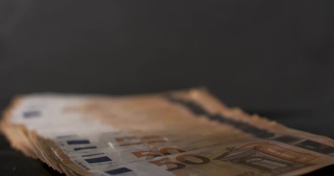 Money bills stacked with slow motion details of movement and texture