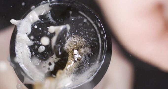 Super slow motion opening beverage can with splash and flying droplets