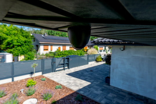 Security dome camera monitoring modern home yard activity