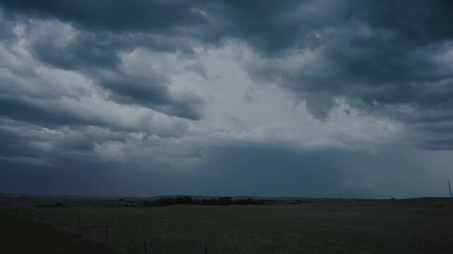 Powerful storm front with flashing lightning in dark clouds