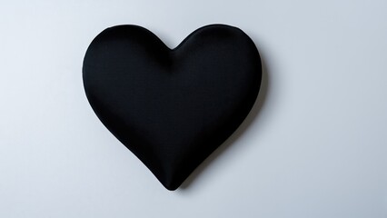 Fototapeta premium Black Heart Symbol: A solitary black heart emblem, representing complex emotions and a bold statement, isolated against a clean backdrop.
