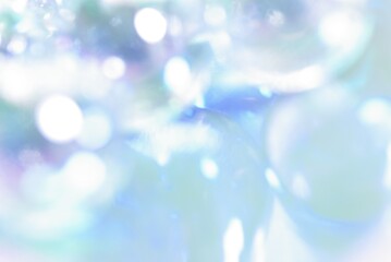 Naklejka premium 水色背景にキラキラ光る抽象的な背景素材