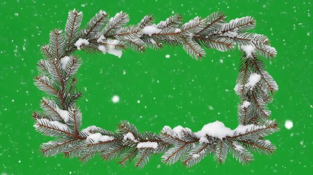 Rectangular frame made of snow covered pine tree branches isolated on green screen chroma key background.