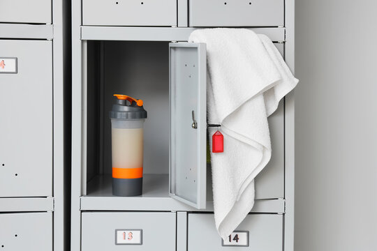 Open gym locker with protein shaker and white towel