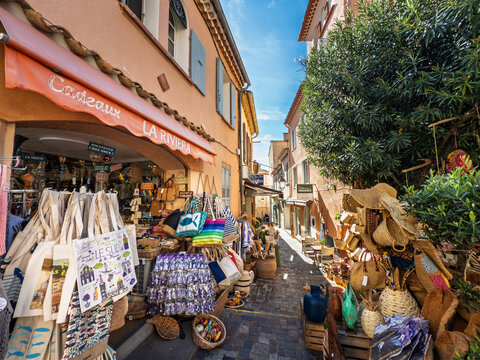 LE LAVANDOU, FRANCE - SEPTEMBER 30, 2025: Sunlit souvenir shop along a street in Le Lavandou old town, Provence souvenirs displayed in village storefronts in a typical French Riviera setting in France