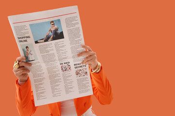 Person reading newspaper with orange background