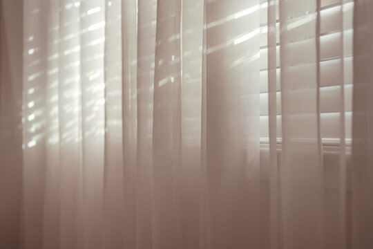 curtains, blinds, sunlight, window, shadow, interior, light filtering through sheer drapes in a quiet room, creating a peaceful and serene atmosphere for home decor concept.