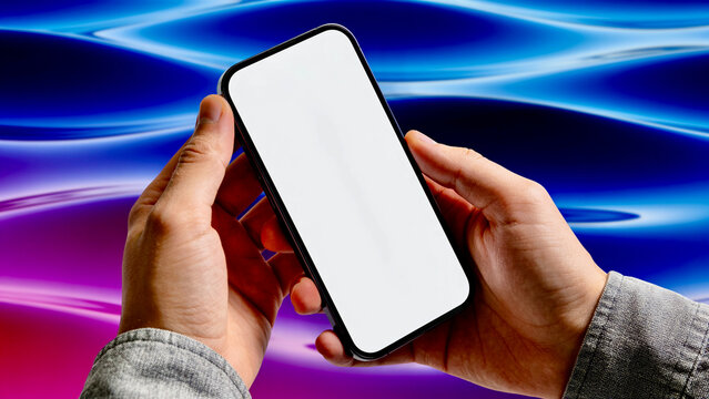 Close up of male hands holding a smartphone with a blank white mockup screen against a wavy neon blue and pink background.