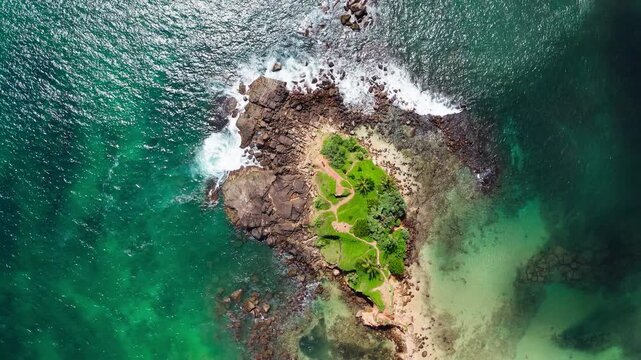 Parrot Rock Hill washed by Indian ocean waves flying drone beautiful Nature's landmark 4K video in Mirissa, Matara District on Sri Lanka. Exotic Asian countries and around the World traveling concept