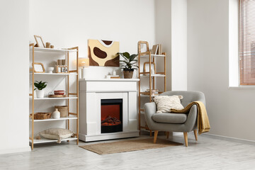Obraz premium Interior of modern room with fireplace, shelving units and armchair