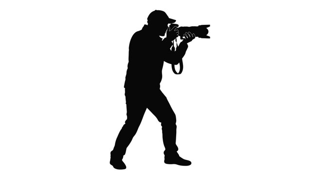 Professional male photographer wearing a baseball cap stands while holding a large heavy camera lens to capture high quality artistic images against a plain white background