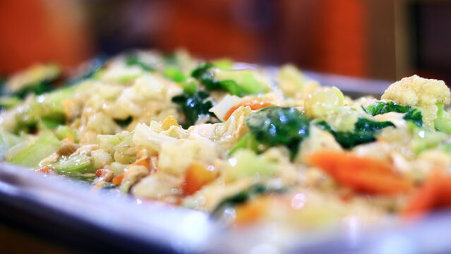Vegetable capcay. Stir-fried carrots, broccoli, cauliflower, mustard greens, and baby corn combined with meatballs, chicken, and shrimp.