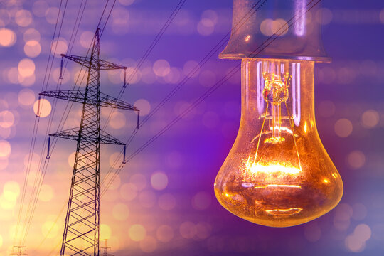 Power transmission network engineers monitor high-voltage grid lines while illuminated light bulb symbolizes electricity supply and energy distribution system