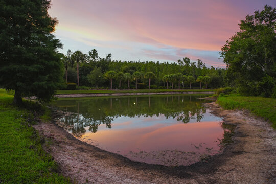  a florida community pond with sunset and colorful cloud