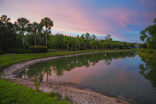  a florida community pond with sunset and colorful cloud