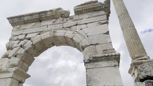 monumental stone archway and standing column in the ancient city of Sagalassos, Turkey. Classical Roman architecture