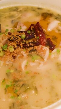 Spicy Sichuan Fish Soup with Chili Peppers in White Bowl