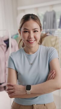 Young adult asia woman people smile look at camera work happy old used heap shirt sale online second hand sell thrift store. Go green eco fabric reduce zero waste issue side hustle small home shop.