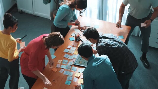 Top view of skilled programmer brainstorming idea about mobile phone interface while develop app development by using wireframe prototype. Web designer planning at table with sticky notes. Symposium.
